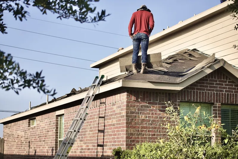 Professional roofer working on a residential roof in Lakeway